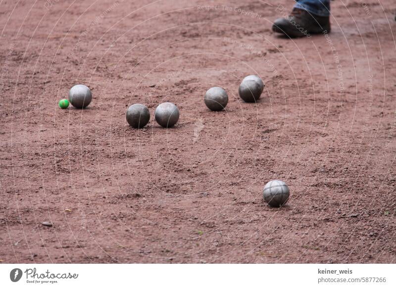 Boules or pétanque on red earth Petanque Sphere Playing Bouel game Petanque court Boules court Metal balls Iron balls Feet Ground Earth Red Sow Swine