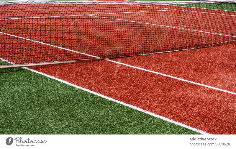 Close-up of a red and green artificial tennis court sport boundary line net detail surface playing outdoor recreation facility game equipment vibrant synthetic