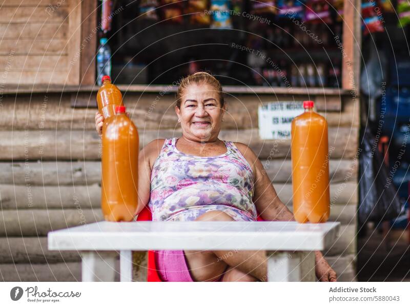 Colombian woman selling traditional Guarapo in bottles colombia guarapo market drink culture colombian beverage cane sugar honey seller stand cheerful display