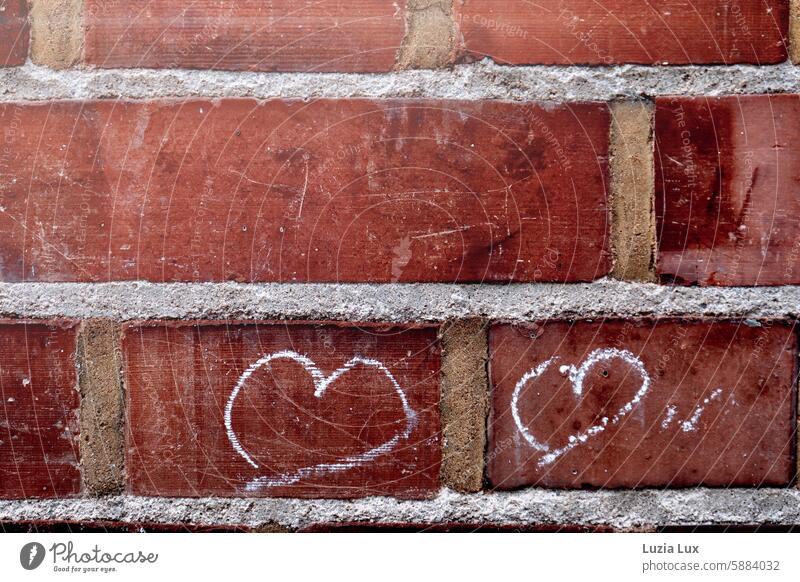 Two hearts on red brick, big city love two Heart Love Infatuation Happy Emotions Romance Display of affection Declaration of love With love Sign symbol Stone