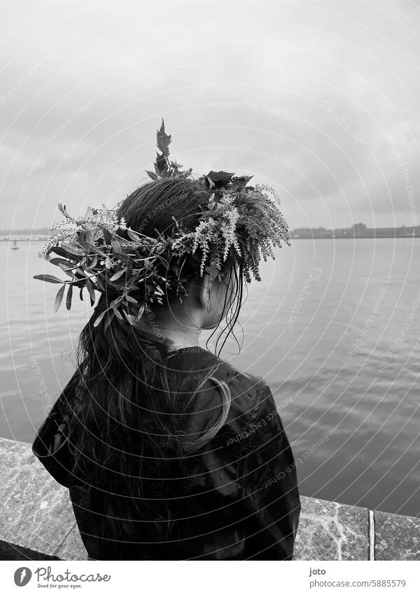 Child from behind with flowers in her hair on a rainy day rainy weather Autumn Autumnal autumn atmosphere Rain Weather Gray somber Dreary Rainy weather