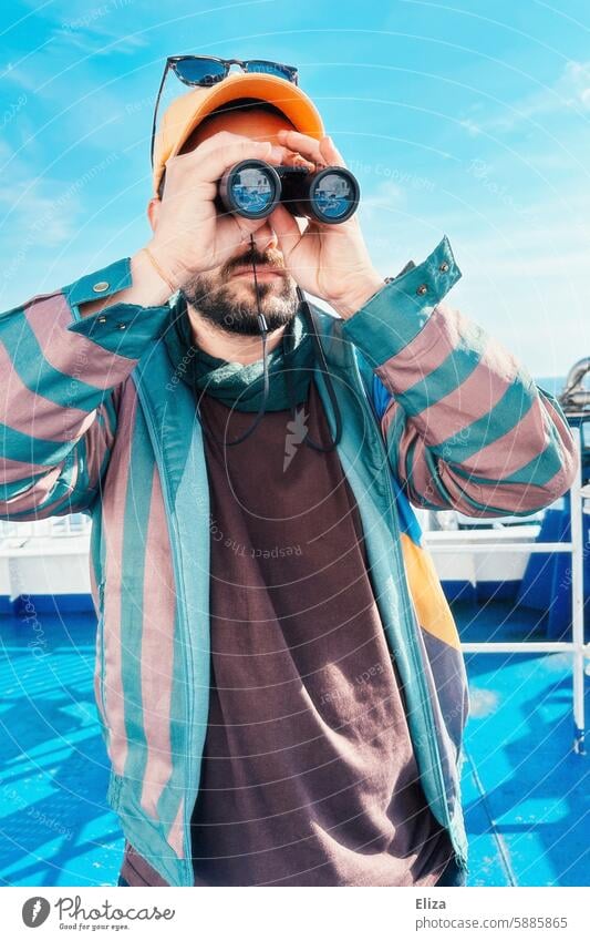 Man observing something through binoculars Binoculars search Amazed inquisitorial Observe Human being Hipster Looking Discover portrait bearded Modern Blue