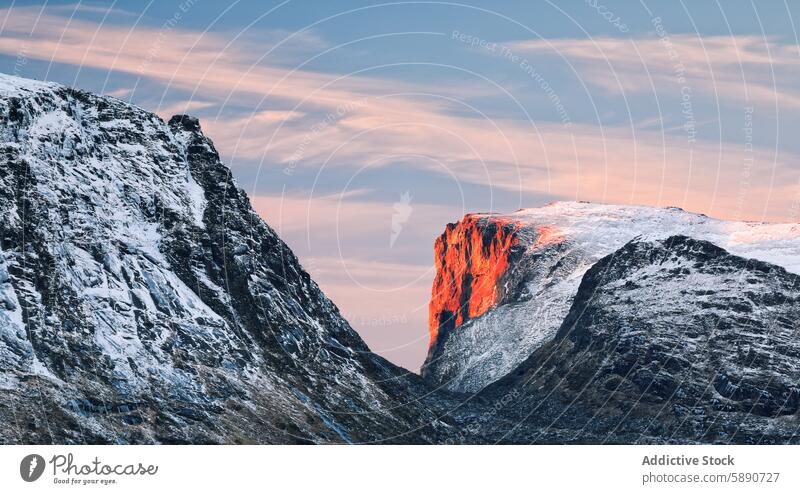 Sunlit peak during winter in Lofoten, Norway mountain sunset snow lofoten norway red glow landscape nature scenic outdoors cold arctic north travel tourism