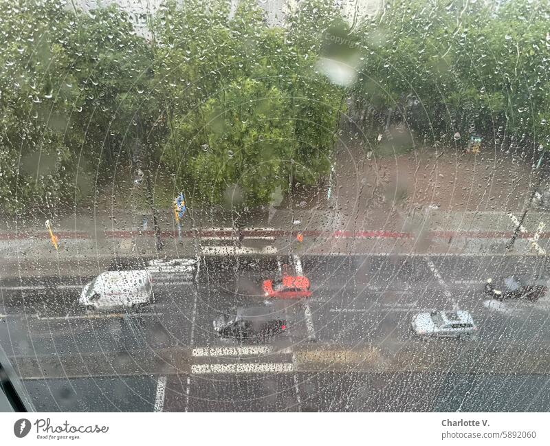 Rainy day I View through a wet window pane onto a busy street - bird's eye view rainwater rain-soaked road Window pane Wet Drops of water Weather raindrops