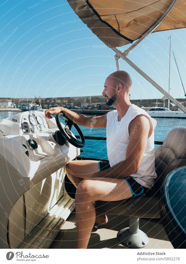 Man steering boat on sunny summer day holiday man motorboat harbor water luxury seashore vessel recreation marine travel navigation leisure skipper sunshine