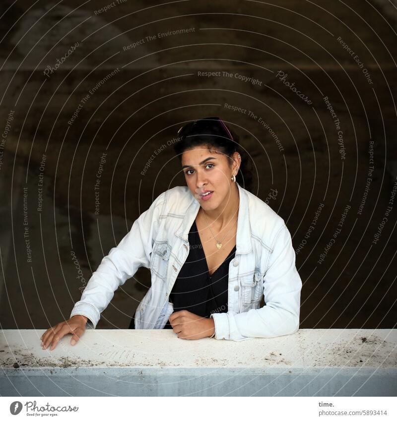 Woman at the window of a parking garage Skeptical Looking portrait Parking garage Concrete Jeans jacket Feminine Self-confident Jewellery stop Lean Rebel