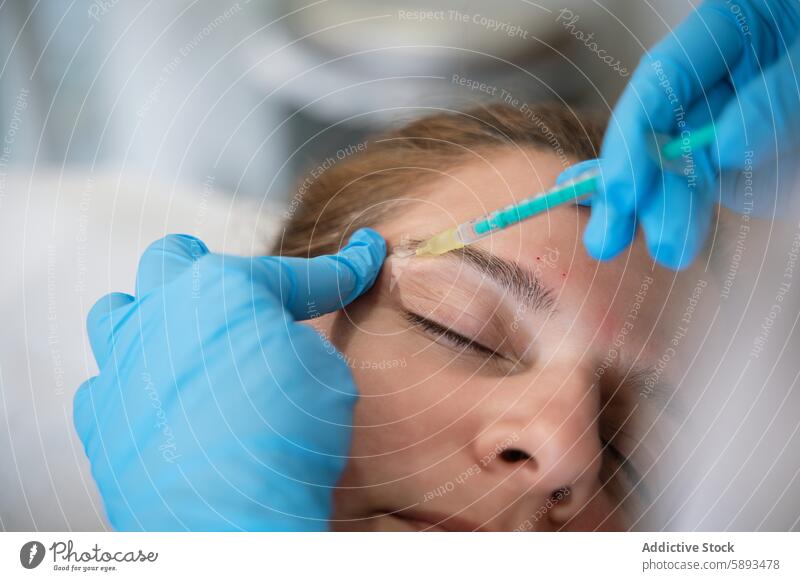 Woman receiving facial injection during rejuvenation treatment in clinic woman administer beauty client dermatologist receive rejuvenate hand glove salon