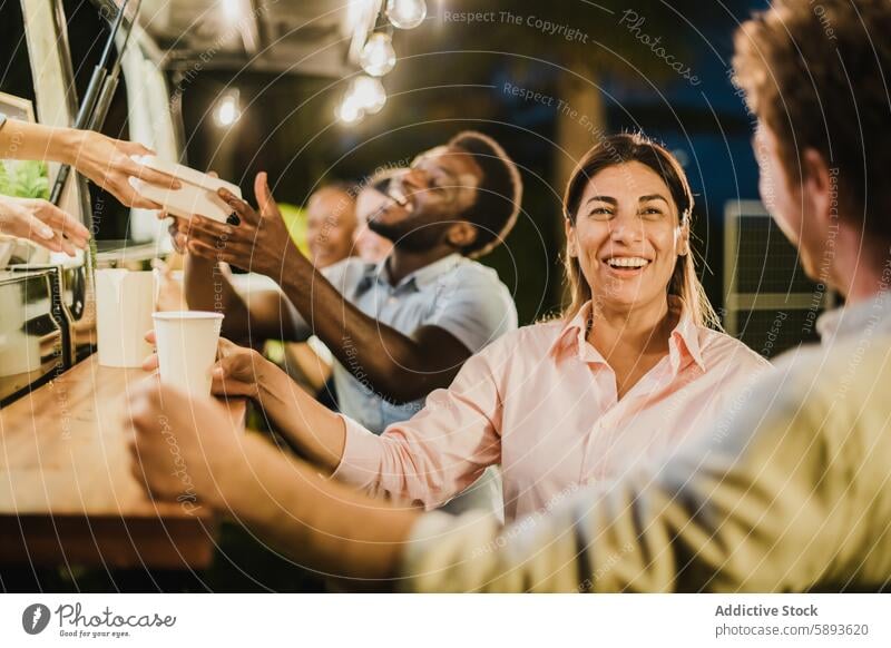 Hispanic woman speaking with friend outside food truck evening smile happy takeaway drink rest talk joy weekend coffee tea carefree diverse multiracial