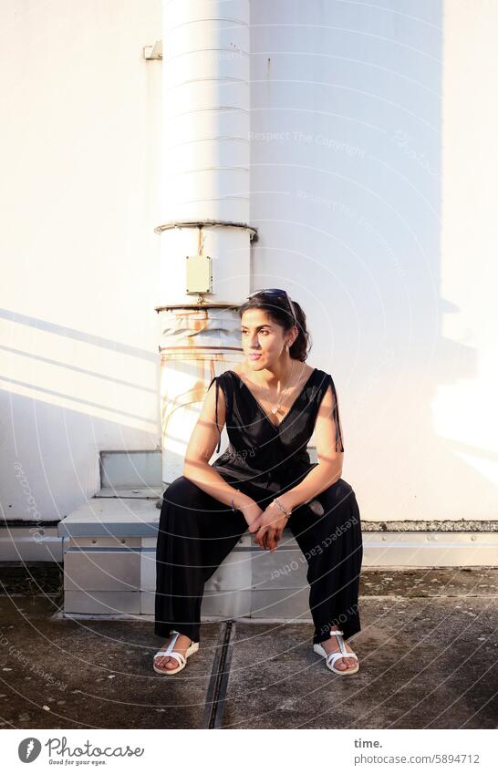 Woman on a parking deck in the evening sun Concrete Parking garage test Observe portrait Looking Long-haired Feminine Jewellery Rest on Curiosity Half-profile