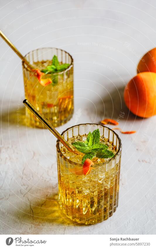 Summer drinks with peppermint on a gray table. Beverage Cold drink Cocktail Glass Colour photo Lemonade Longdrink Delicious Fresh Ice cube Alcoholic drinks