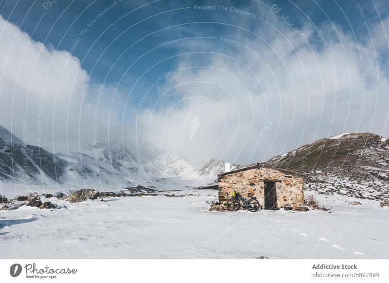 Snow-covered mountain shack in Palencia snow landscape curavacas espiguete palencia serenity blue sky winter solitude stone isolated scenic peak nature outdoor