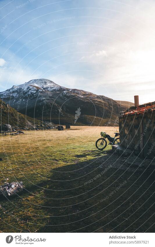 Mountain biking at sunrise in the Spanish highlands mountain bike spain palencia curavacas espiguete rustic stone hut snow peak morning serene nature outdoor