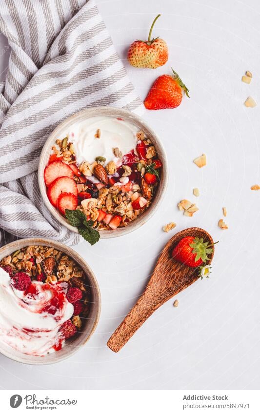 Summer breakfast bowls with yogurt, fruits and granola summer strawberry raspberry nut mixed fresh top view healthy meal morning diet lifestyle vegetarian snack