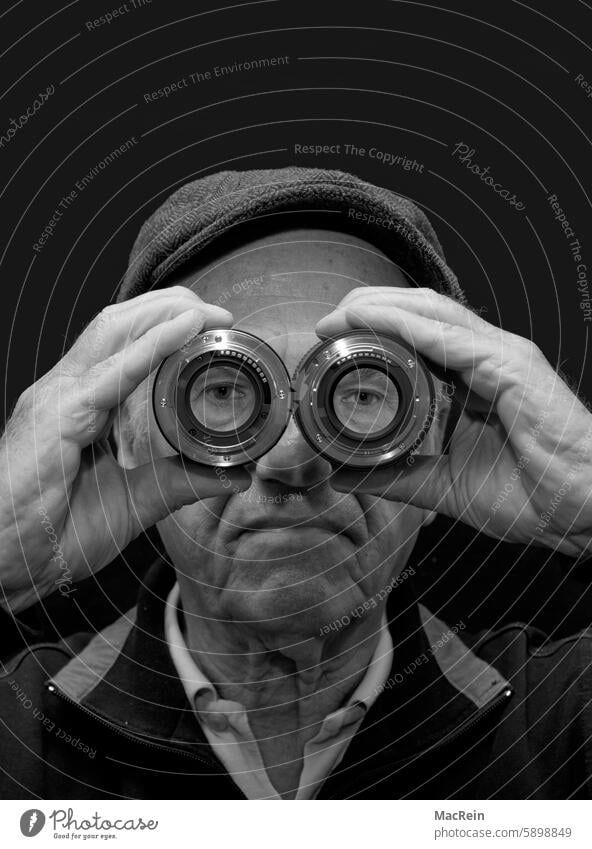 Man looking through two lenses Objective Lenses Cap looks Vista Optics Eyeglasses stop