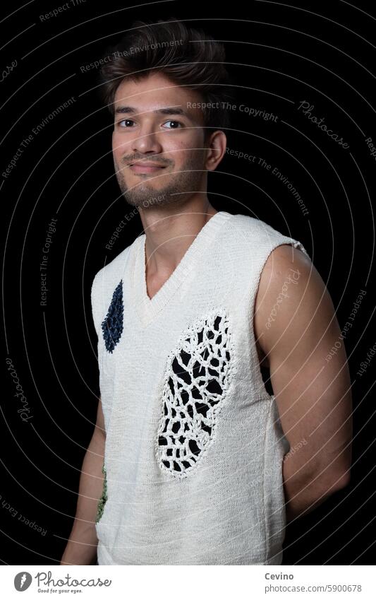 Young man from India in a sleeveless shirt Man Athletic sexy portrait Muscular kind Congenial muscle Strong arms black background Flash photo Studio shot