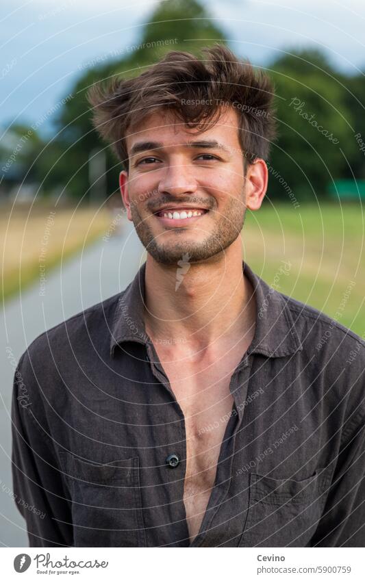 Portrait of a young man from India with an open shirt Man Athletic sexy Muscular kind Congenial Looking into the camera full of relish Exterior shot Nature