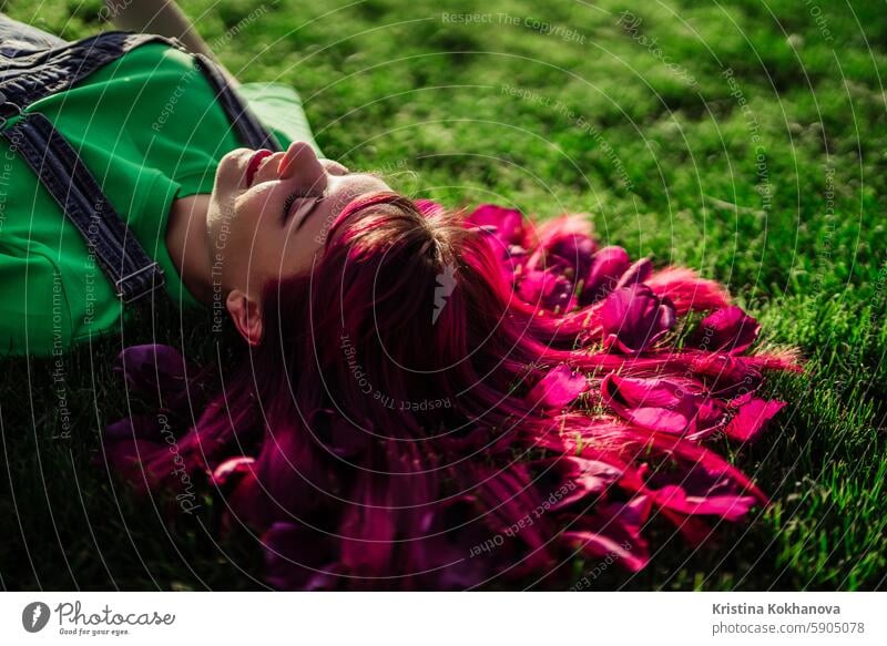 Portrait of real serene woman with vivid dyed pink fuchsia hairstyle. Trendy colorful hair, stylish haircut beautiful beauty fashion background female girl