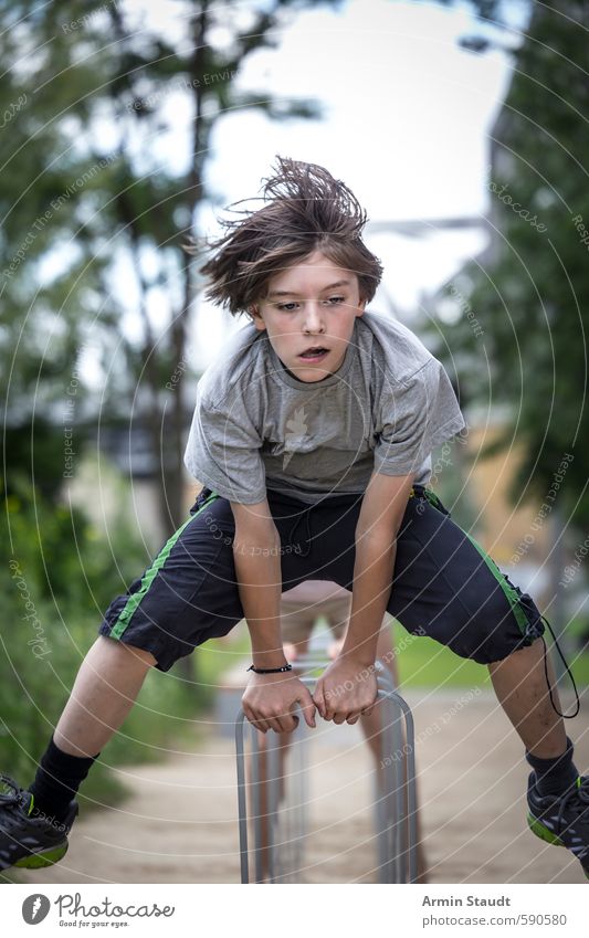 Boy jumps over a bicycle stand Lifestyle Jump Summer Sports Human being Masculine Youth (Young adults) 1 8 - 13 years Child Infancy Nature Park Berlin Town