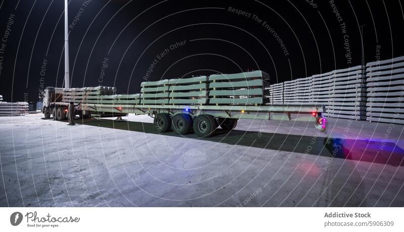 Railway Sleepers Stacked for Transportation at Night railway sleeper stack transport truck night interior design project green painted cargo logistics industry