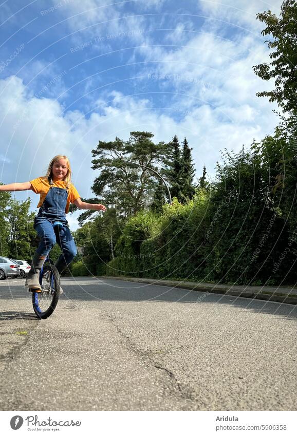 Child riding a unicycle on the road Unicycle Bicycle Driving Girl Cycling Infancy Mobility Lanes & trails Street Movement Leisure and hobbies Athletic Wheel