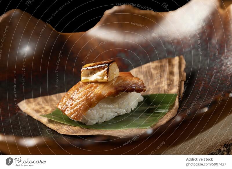 Exquisite sushi with grilled fish and rice on leaf bamboo leaf ceramic dish rustic elegant presentation food cuisine japanese sticky asian gourmet traditional