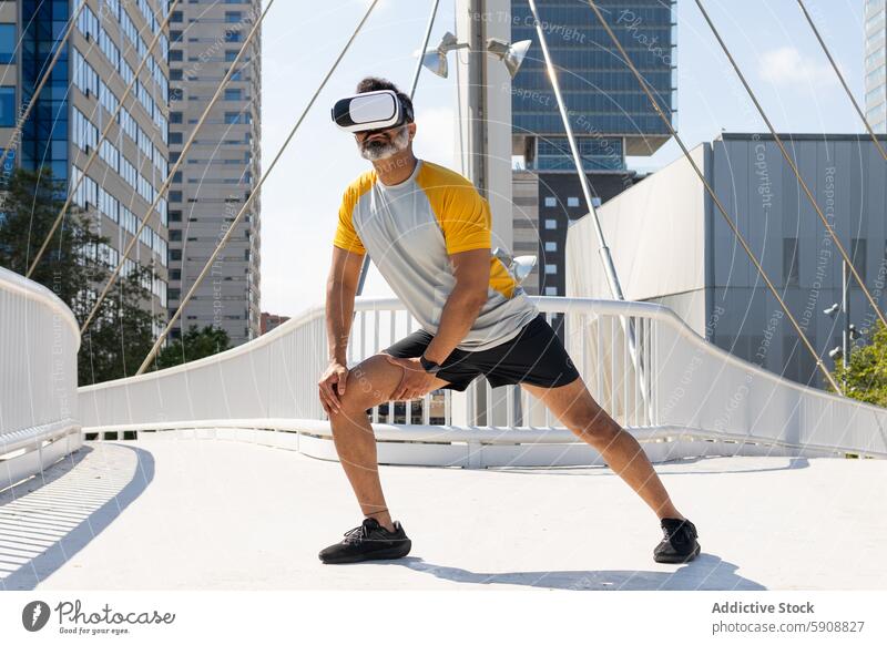 Indian man in VR headset exercising in urban setting indian virtual reality vr headset city skyscraper bridge sports attire fitness technology gadget device