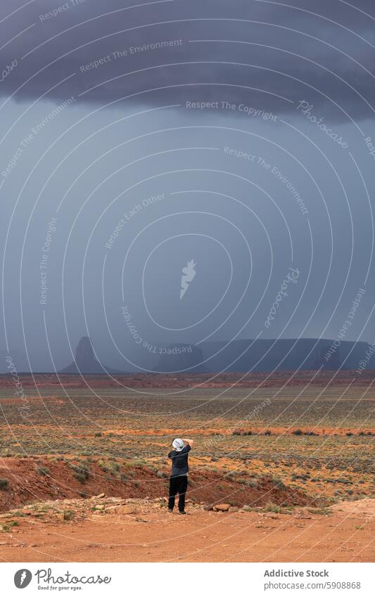 Lone observer captures the storm at Monument Valley monument valley desert landscape photography nature solitude dramatic vast horizon mesas wilderness scenic