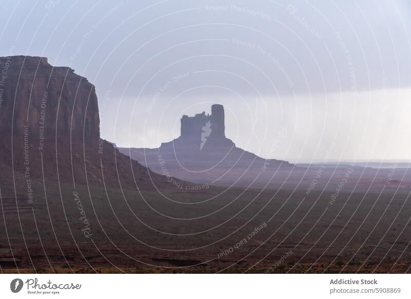 Lightning strike in Monument Valley during a storm monument valley lightning rock formation gloomy sky weather natural landscape thunderstorm outdoor dramatic