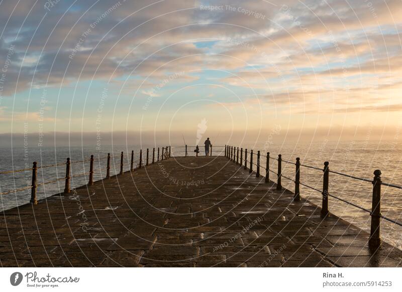 Angler in the sunset Sunset Ocean Atlantic Ocean Horizon Considerations atmospheric vacation tranquillity Footbridge Twilight Fishing (Angle) Clouds Relaxation