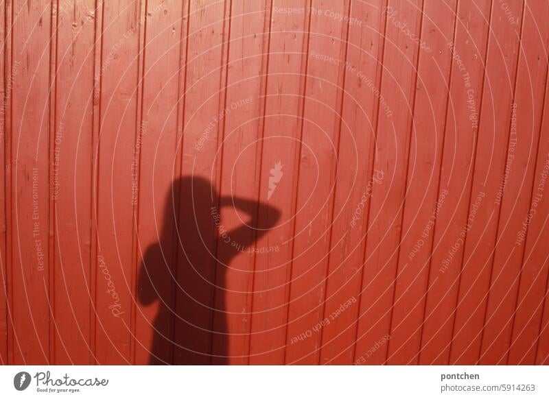 look ahead. shadow of a child on a red board wall Shadow Child Red Sun Movement outlook Future arm Body Exterior shot Colour photo Beautiful weather