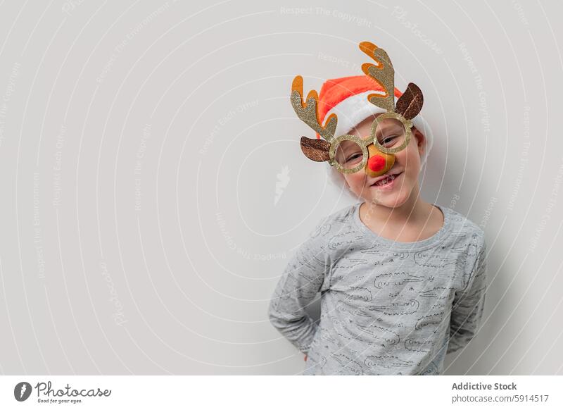 Young child dressed as a reindeer for Christmas celebration christmas costume holiday festive smile joy cheerful white background young decoration antler