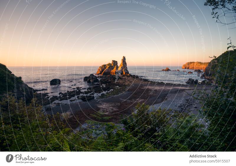 Sunrise over rock formations at Llanes beaches in Asturias sunrise llanes asturias sandy shore playa de pendueles landscape seascape coastline morning light