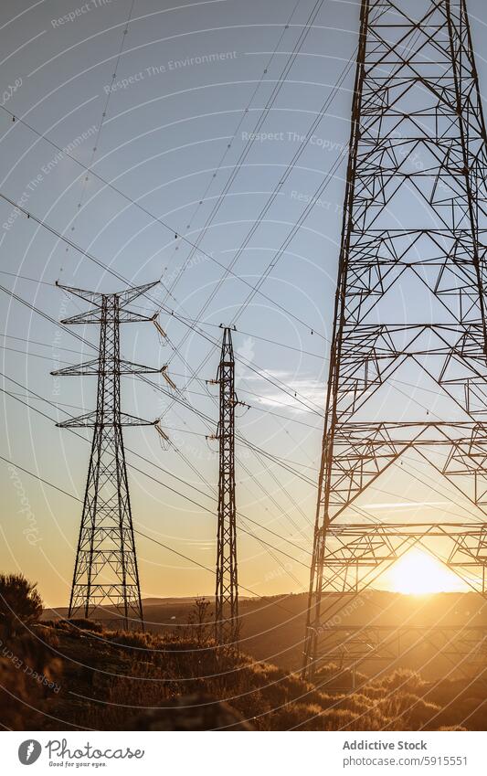 Sunset view of power lines from a Spanish hydro plant sunset transmission tower electrical grid hydroelectric plant spain energy infrastructure rural