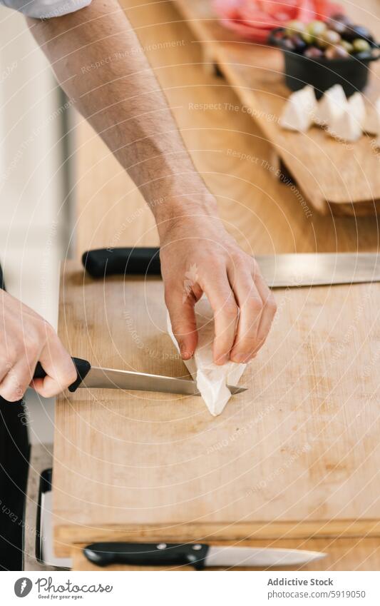 Private chef preparing food on cutting board cooking kitchen knife hand male preparation culinary private chef gourmet fresh ingredient close-up cropped