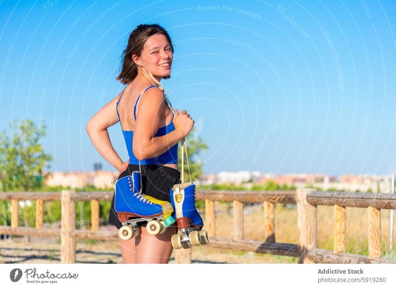 Young woman enjoying roller skating in sunny skate park roller skate outdoor sport leisure activity summer fitness healthy lifestyle recreation fun happy