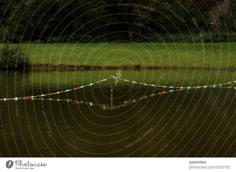 pretty, colorful, barrier chain reflected in the lake. boundary. Lake Chain Shut-off chain variegated colored Water Nature reflection cordon Safety