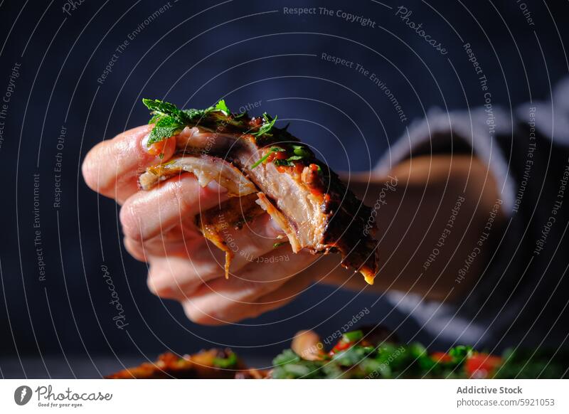 Woman holding delicious rib taco close-up, dark background woman hand food cuisine mexican savory juicy seasoned herb garnish tasty meal dinner snack fresh