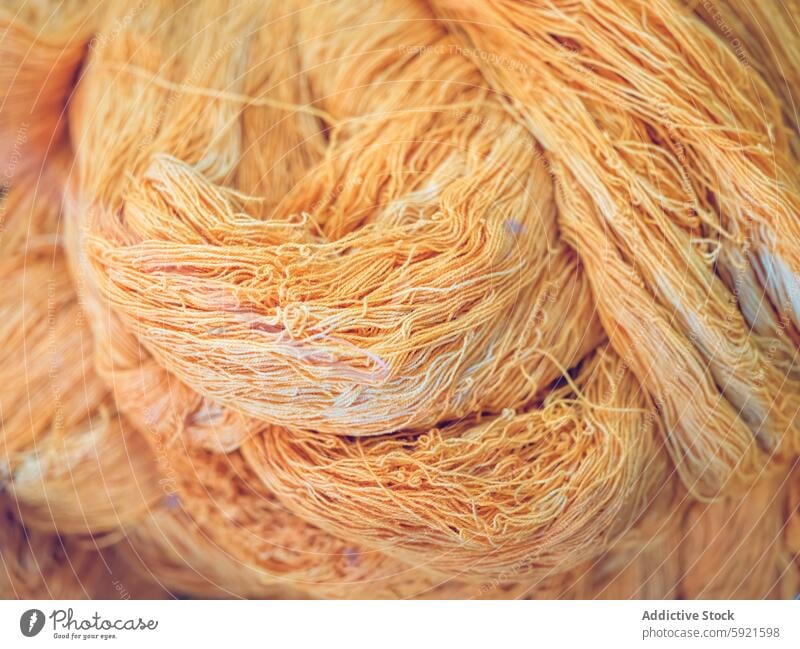 Close-up of golden yarn bundles in textile production factory close-up fiber material thread industry manufacturing intricate texture woven craft fabric cotton