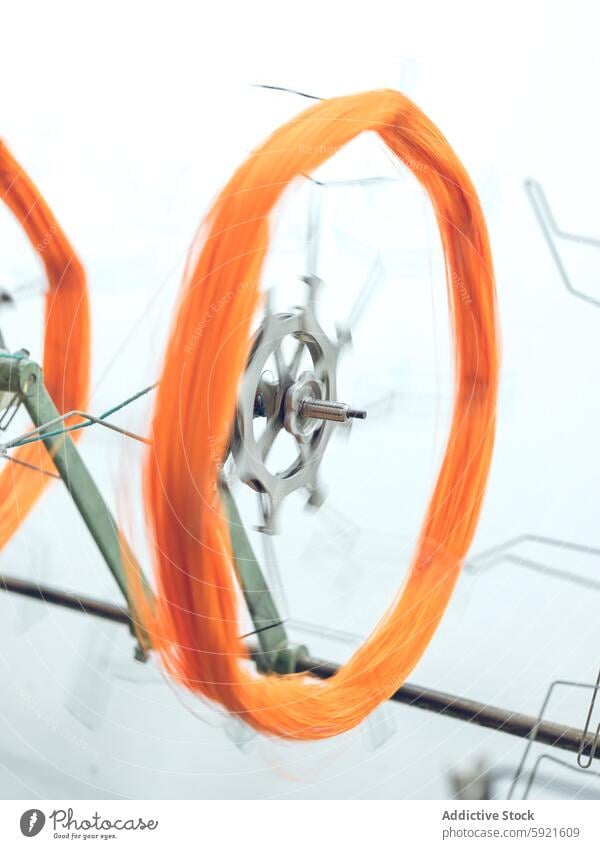 Spinning orange yarn on textile machinery spinning industrial factory production thread vibrant cotton textile production manufacturing equipment industry fiber