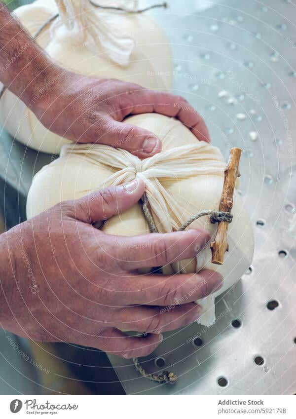 Traditional Mahon cheese being handcrafted with care mahon menorca dairy tying traditional artisan food milk product skill close-up handmade dairy industry