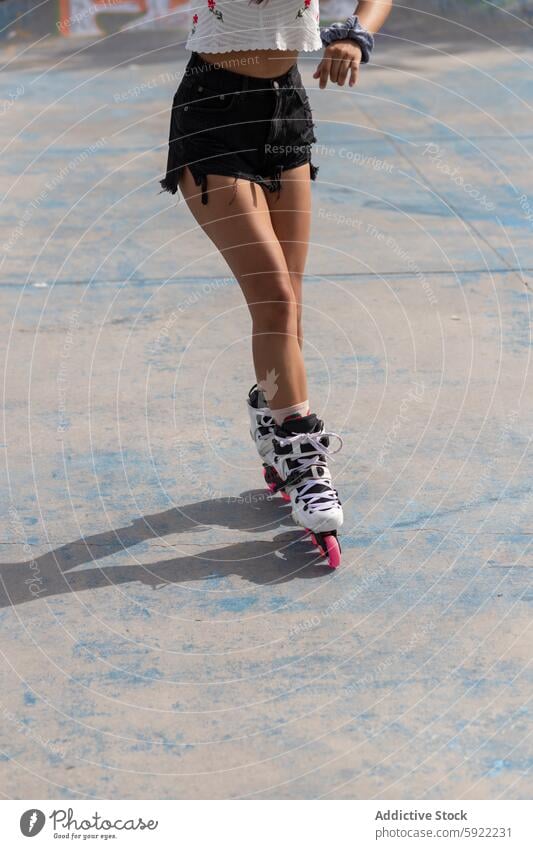 Woman in roller blades in skate park woman pavement sport leg training wellness activity lifestyle hobby workout sporty exercise active young motion fun leisure