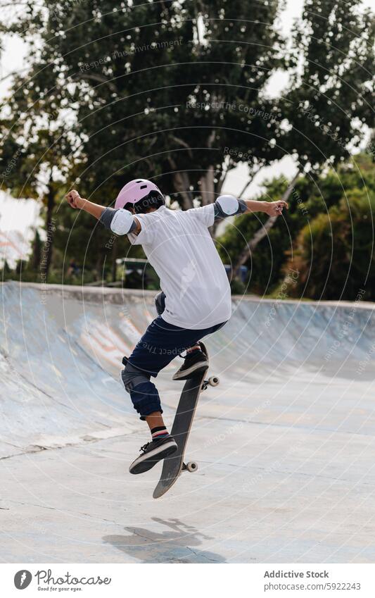 Young person with skateboard in skate park protect ride training hobby skater helmet extreme motion energy ramp pool active practice activity sport subculture