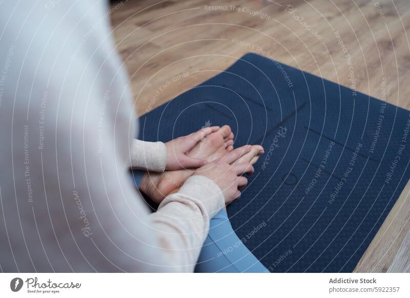 Yoga practitioner seated on mat in meditation pose person yoga sitting back hands knees mindful wellness practice indoors exercise relaxation fitness health