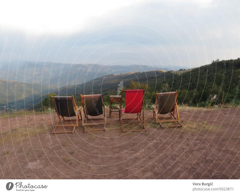 Four chairs with view on the mountain mountain view scenic seating outdoor chairs panoramic landscape mountain retreat peaceful setting nature view