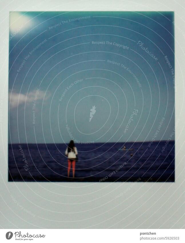 polaroid shows rear view of a woman in pink pants standing by the sea. north sea Polaroid Ocean North Sea Woman Back Rear view Stand sneeze wide Far-off places