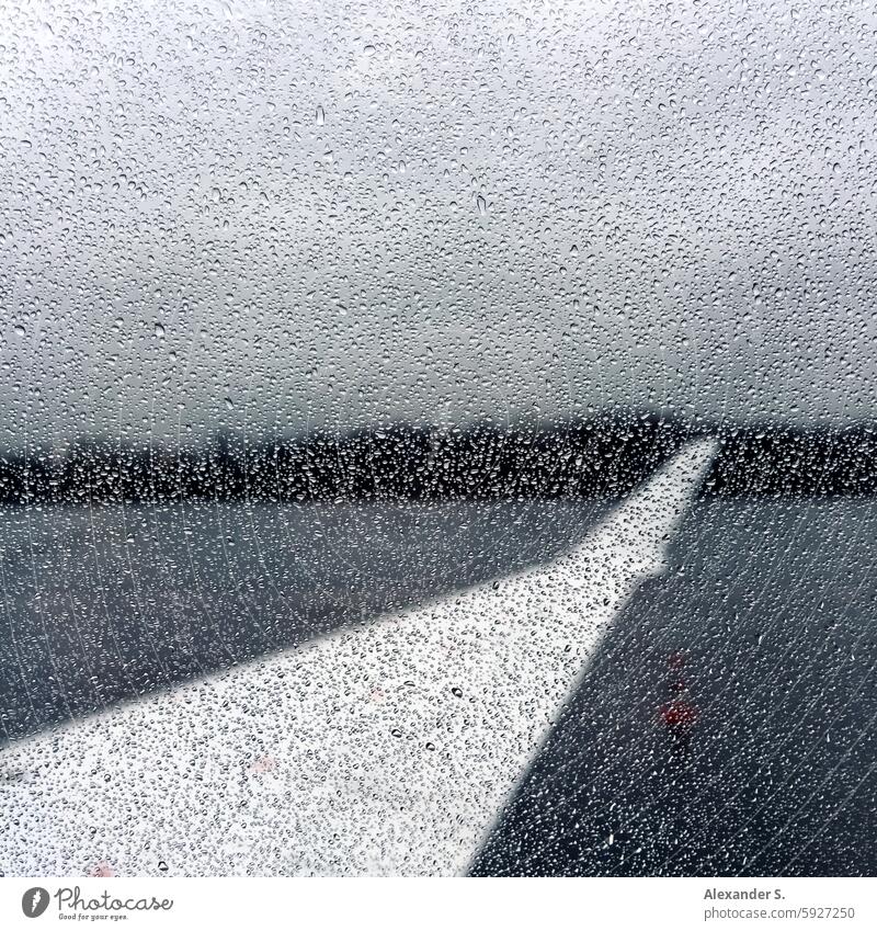 Wing of an airplane through a window pane with raindrops Airplane Grand piano Aviation Vacation & Travel View from the airplane Flying Passenger plane