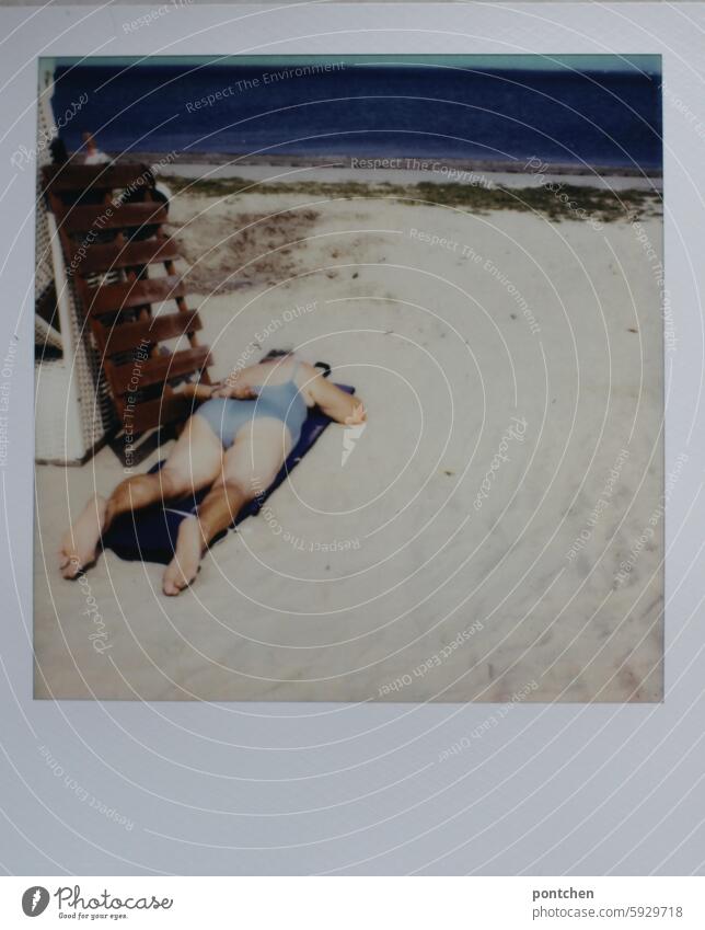 polaroid shows sunbathing woman in swimsuit in prone position on a sun lounger on the beach Polaroid Beach North Sea Woman Senior citizen Old Swimsuit