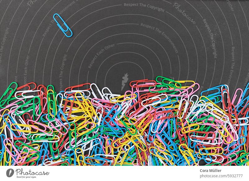 Colorful paper clips on a black board surface variegated Office background Holder Copy Space Many Blackboard Contrast graphically Individual texture peg Red