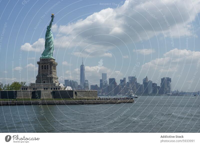 Iconic view of the Statue of Liberty and Manhattan skyline statue liberty manhattan new york freedom architecture water river boat cloud monument landmark city