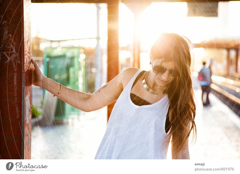 Young woman at train station in evening light Feminine Youth (Young adults) 1 Human being 18 - 30 years Adults Sunglasses Hair and hairstyles Brunette